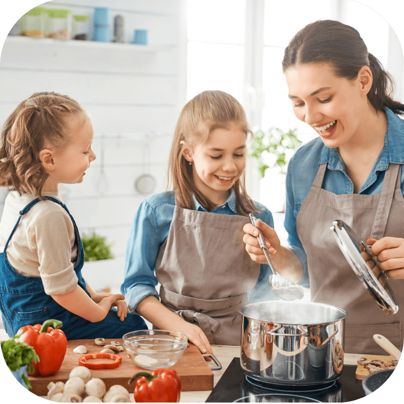 Mother and children cooking together in a bright kitchen, highlighting a warm, family-focused home environment enhanced by comfort and everyday living.